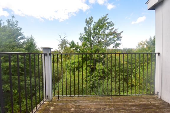 a balcony or terrace with a fence and a garden at Heatherwood Apartments, Michigan