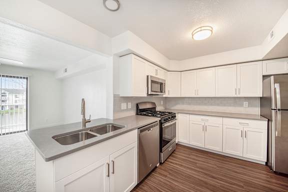 apartment kitchen with stainless steel appliances at Dupont Lakes Apartments in Fort Wayne, IN 46825