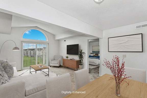 A living room with a cathedral ceiling at Dupont Lakes Apartments in Fort Wayne, IN