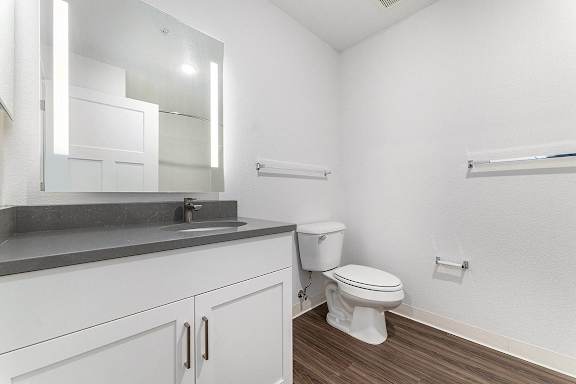 A bathroom with a large vanity and mirror at Eagle Ridge Apartment Homes, Traverse City, Michigan