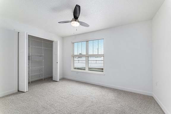 Bedroom with large closet and window at Eagle Ridge Apartment Homes, Traverse City