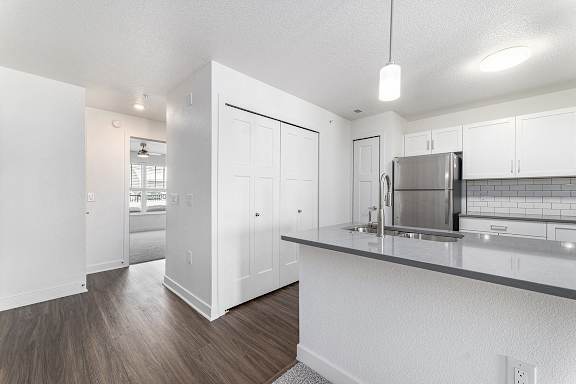 A kitchen with white cabinets and a stainless steel refrigerator at Eagle Ridge Apartment Homes, Traverse City, Michigan