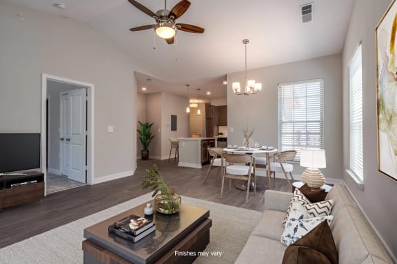 a living room and dining room with a ceiling fan at Emerald Creek Apartments, Greenville, South Carolina