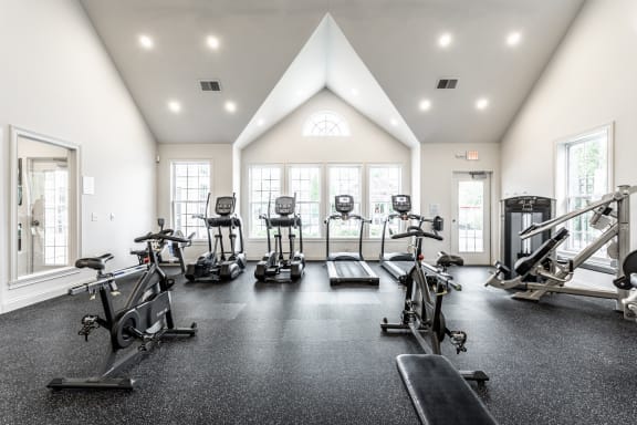 a gym with treadmills and other exercise equipment  at Enclave Apartments, Midlothian