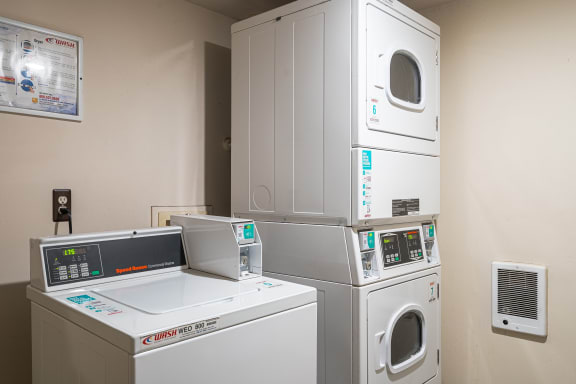 a laundry room with four washing machines and a washer and dryer at Lake in the Pines, Fayetteville
