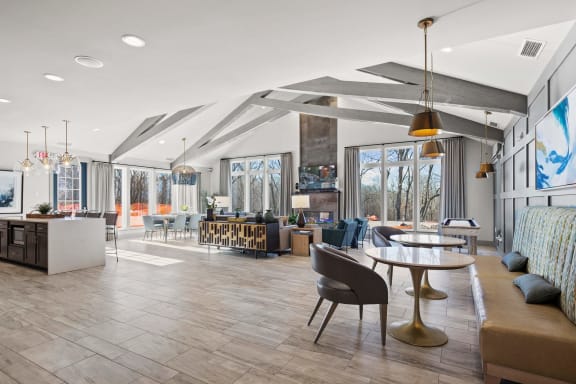 a clubhouse filled with furniture and a large window at River Hills Apartments, Fond du Lac, WI