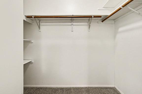 A walk-in closet with shelving at Emerald Park Apartments, Kalamazoo, Michigan