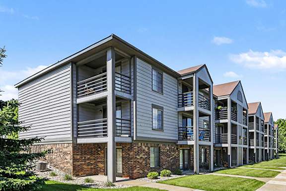 A building with balconies and patios at Emerald Park Apartments in Kalamazoo, MI