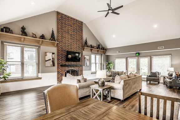 A living room with a fireplace and a couch at Huntington Cove Apartments, Merrillville, IN