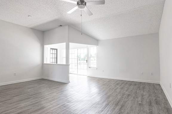 an empty living room with white walls and a ceiling fan at Latitudes Apartments, Indianapolis, IN