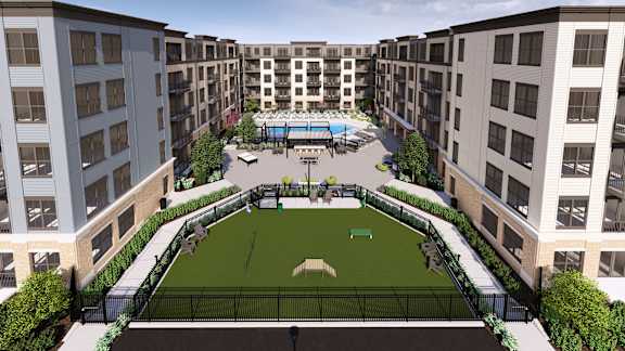 Dog park and lawn area with courtyard amenities at Icon on Main Apartments, Indiana, 46032