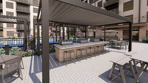 Outdoor kitchen bar with covered pergola and seating at Icon on Main Apartments, Carmel, IN 46032