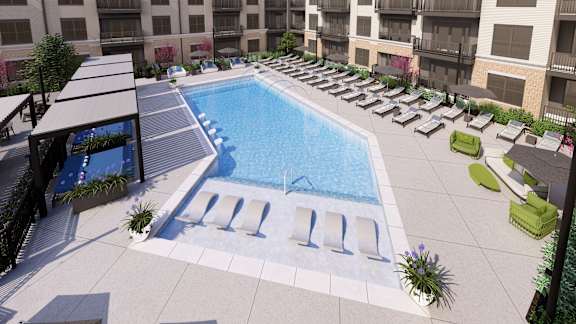 Pool deck with cabanas and lounge chairs at Icon on Main Apartments, Carmel, IN