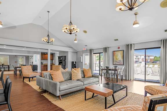 A living room with a grey couch at Bay Pointe Apartments, Indiana