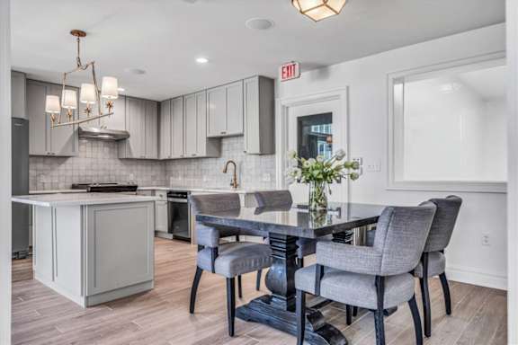 a kitchen and dining room with a table and chairs at The Vinings Apartments in Richmond, VA 23234