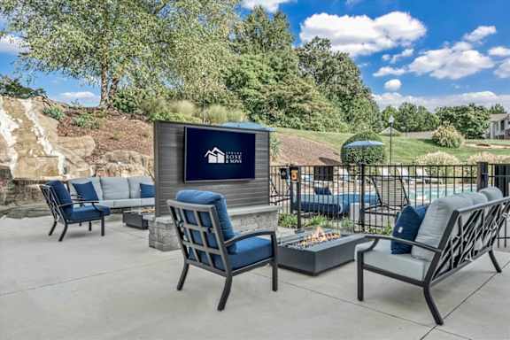 the clubhouse patio with chairs and a fire pit at The Vinings Apartments in Richmond, VA 23234
