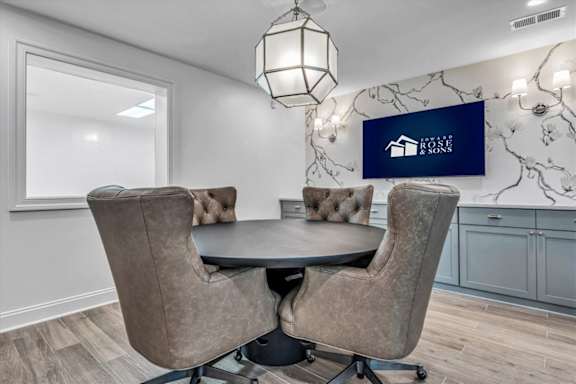 a dining room with a table and chairs at The Vinings Apartments in Richmond, VA 23234