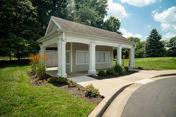 A small white house with a porch and a covered walkway at Latitudes Apartments, Indiana, 46237