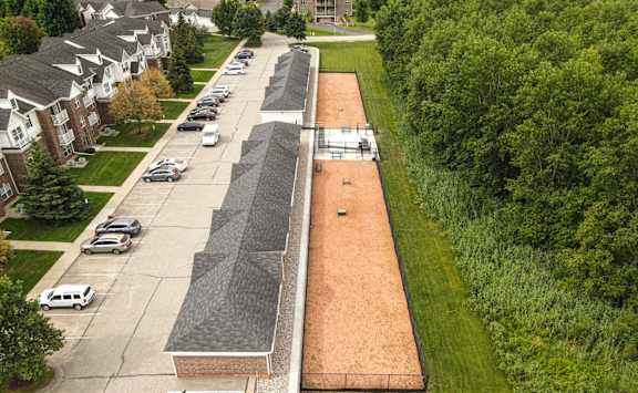 A long parking lot with cars parked in its at Towne Lakes Apartments, Grand Chute, 54913