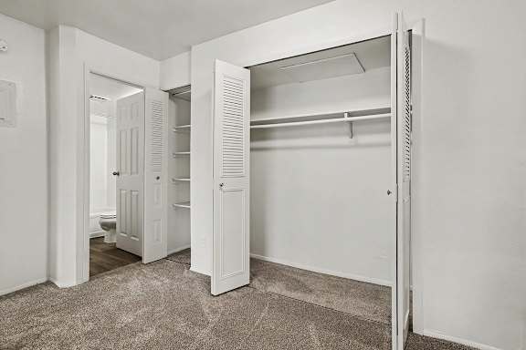 Bedroom with walk-in closet and bathroom access at Fairlane Apartments, Michigan