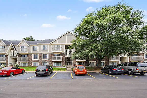 Apartment community exterior with parking and landscaping at Fairlane Apartments, Springfield, MI 49037