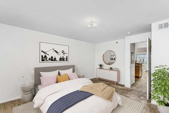a bedroom with a bed and a mirror and a closet at Fieldstream Apartment Homes in Ankeny, IA