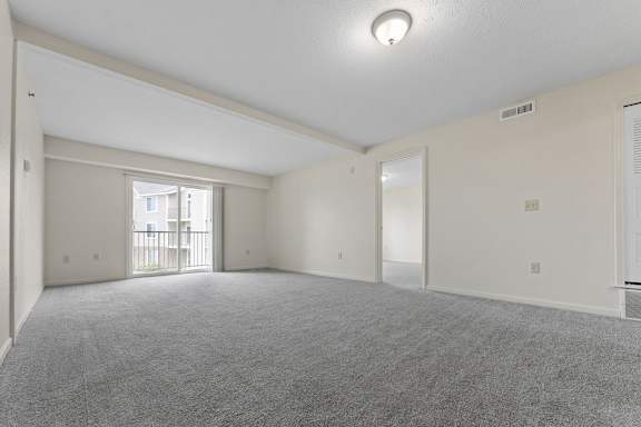 A spacious living room with a carpeted floor at Fieldstream Apartment Homes, Iowa