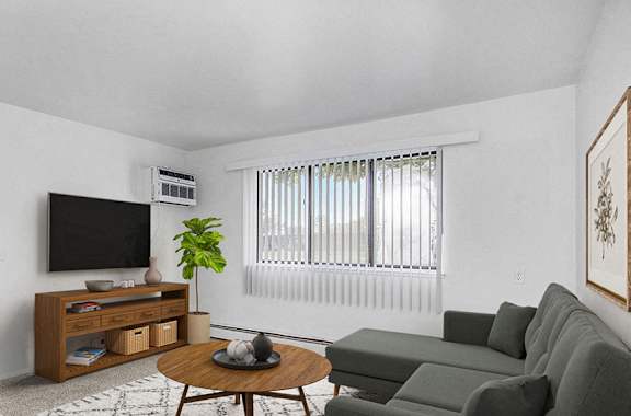A garden style living room with a large window at Glen Oaks Apartments, Michigan, 49442