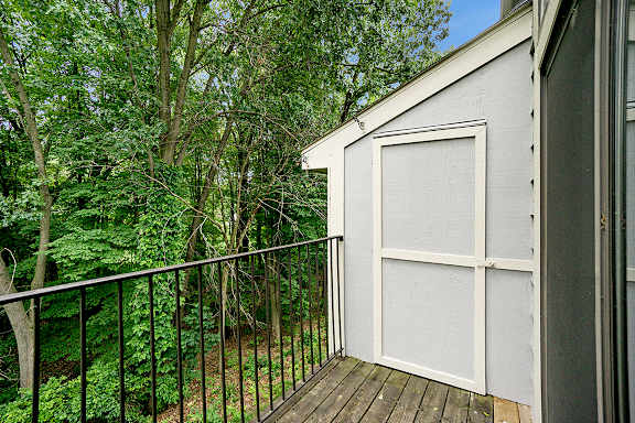 A private balcony with a black railing and enclosed storage at Glenn Valley Apartments, Battle Creek, MI, 49015