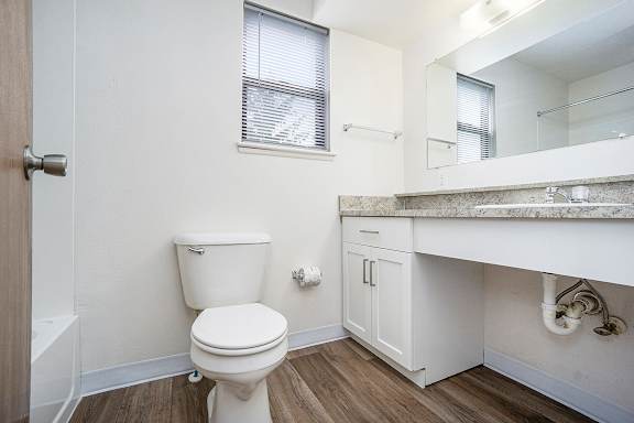 An upgraded bathroom with a hard-surface floor at Glenn Valley Apartments, Battle Creek, MI, 49015