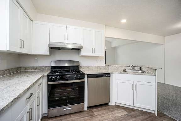 A kitchen with stainless steel appliances and a breakfast bar at Glenn Valley Apartments, Battle Creek, MI, 49015