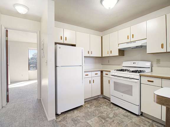 A kitchen with a white refrigerator, stove, and dishwasher at Glenn Valley Apartments, Michigan, 49015