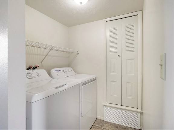 A small laundry room with a washer and dryer at Glenn Valley Apartments, Michigan, 49015
