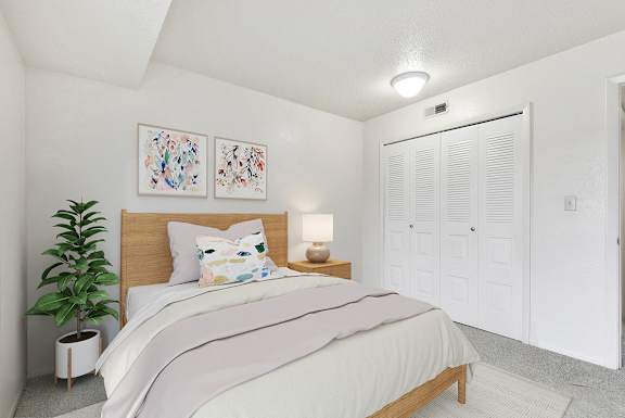 A bedroom with a large closet at Granada Apartments, Jackson, 49202