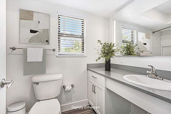 a bathroom with a toilet and a window at Green Ridge Apartments, Grand Rapids, MI