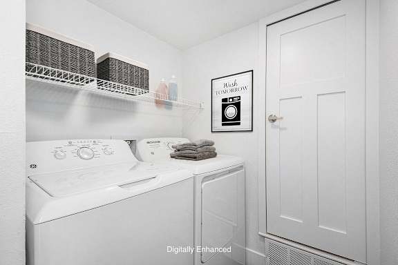A laundry room with a washer and dryer at Green Ridge Apartments, Grand Rapids, 49544