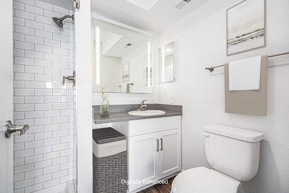 A 2nd bathroom with a white tiled shower at Green Ridge Apartments, Grand Rapids, 49544