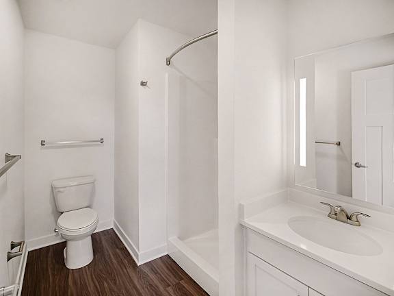 A second bathroom with a toilet, sink, and a shower at The Grove Apartment Homes in Lincoln, NE