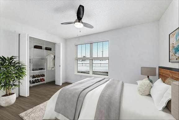 Bedroom with expansive window, ceiling fan and walk-in closet at The Grove Apartment Homes, Lincoln, NE 68512