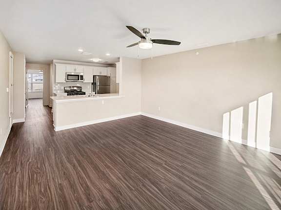 A dining room with a ceiling fan and breakfast bar at The Grove Apartment Homes in Lincoln, NE
