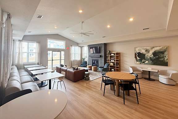 A spacious community building with hard-surface flooring and several windows at The Grove Apartment Homes, Lincoln, NE 68512