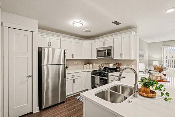 A kitchen with white cabinets and a stainless steel appliances at The Grove Apartment Homes, Lincoln, NE 68512