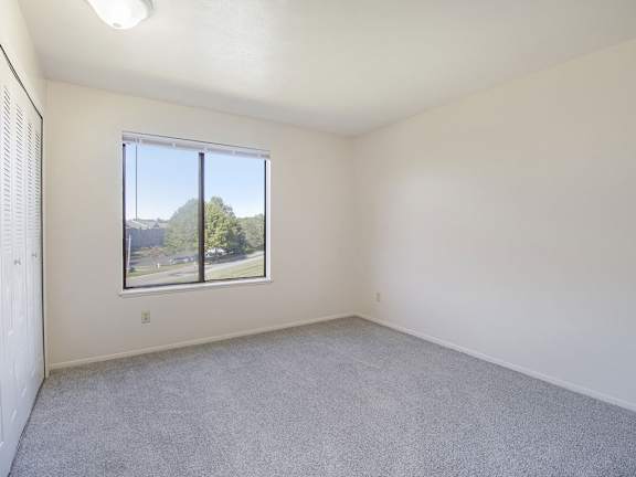 A spacious bedroom with a window at Gull Prairie/Gull Run Apartments and Townhomes, Michigan, 49048