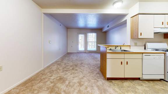 A kitchen with a sink, stove, and dishwasher at Gull Prairie/Gull Run Apartments and Townhomes in Kalamazoo, MI