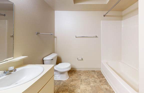 A bathroom with a toilet, sink, and bathtub at Gull Prairie/Gull Run Apartments and Townhomes, Kalamazoo, MI, 49048