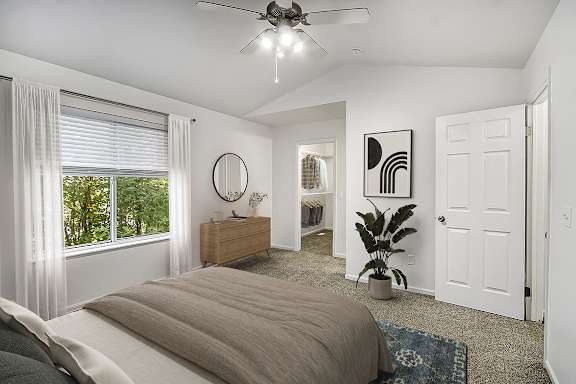 a bedroom with a vaulted ceiling and ceiling fan at Gull Prairie/Gull Run Apartments and Townhomes, Michigan, 49048
