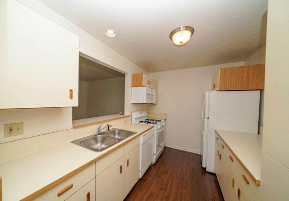 a kitchen with a hard surface floor and a built in dishwasher and microwave at Gull Prairie/Gull Run Apartments and Townhomes, Kalamazoo, MI