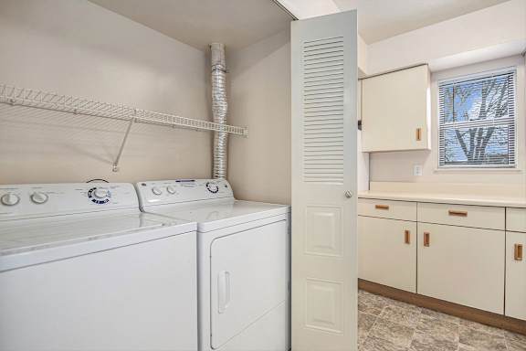 A laundry room with a washer and dryer.