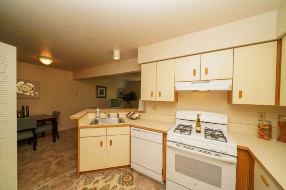 a kitchen with a breakfast bar at Glenn Valley Apartments, Battle Creek, 49015