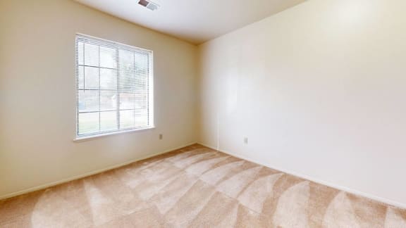 an empty room with a window  at Hampton Lakes Apartments in Walker, MI 49534
